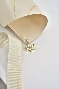 "With this stunning 14K Solid Gold Star of David Chai Pendant, you'll shine like a star. This stunning 18K Jewish Identity David Star Necklace is a timeless representation of life and tradition. This pendant is made of exquisite pure gold and includes a delicate six-pointed star carved with detailed embellishments. The Hebrew word \"life\" is represented by the chai sign in the center, making this a memorable gift for any occasion. Whether you're honoring your faith or reconnecting with your heritage, this beautiful necklace's basic yet elegant design will enhance any look. Give the gift of tradition this holiday season with this handcrafted piece of Jewish jewelry. Details of the product Material: 14K and 18K Solid Gold Elegant Gift For people whom you love; Mom, Girlfriend, Wife, Fiance, Jewish Symbols, Jewish Jewelry, Jewish Gifts, Life Symbol, Star Of David, Pure Gold, Gold Stars, Star Necklace, Unique Necklaces