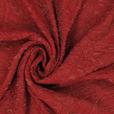 an image of a red fabric with paisley designs on it's edges and bottom