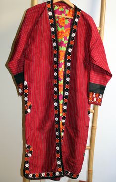 Vintage original kaftan from Turkmen people, Central Asia, with nice embroidery. On the sides and rims the coat has an elaborate embroidered Oriental pattern. The ceremonial coat is worn open and has therefore no buttons, hooks, nor belt. The inside is lined with blue-yellow cotton fabric with a floral print. In very good condition, no signs of heavy wear or repairs.  Size: comparable to European size L shoulder width: 48 cm chest: 56 cm sleeve length: 50 cm cuff width: 13 cm total length: 116 c Traditional Red Kaftan Straight Kurta, Festival Straight Kurta Kaftan With Embroidered Border, Bohemian Straight Kurta Kaftan For Festivals, Intricate Embroidered Straight Kurta Kaftan For Festivals, Bohemian Red Kurta For Eid, Folk Style Embroidered Festival Kimono, Traditional Kaftan With Woven Motifs For Festive Season, Red Long Sleeve Kaftan With Traditional Patterns, Red Bohemian Kurta For Eid