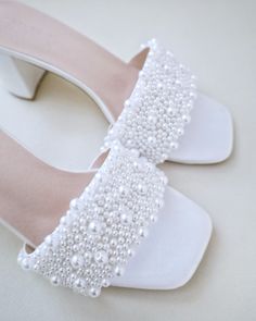 "Classic satin slip on block heel sandals adorned with allover pearls on the vamp for romantic, elegant and feminine look. The delicate pearl beads are placed to create a graceful classic style. Simple and easy wear for bridal wear, bridesmaids, holiday party, wedding parties, and any special occasions.  DETAILS: HEEL HEIGHT: 2.5 Inches COLORS AVAILABLE: Ivory and White UPPER: Synthetic upper and lining MATERIALS: Manmade outsole STYLE NAME: VERONA Not sure of which size to purchase? Shoes measurements are as follow: (Please note measurements taken the length of inside of shoe from toe to heel) Size 5.5 - 9\" Size 6 - 9.25\" Size 6.5 - 9.375\" Size 7 - 9.5\" Size 7.5 - 9.625\" Size 8 - 9.75\" Size 8.5 - 9.875\" Size 9 - 10.125\" Size 10 - 10.375\" Size 11 - 10.75\" - We DO NOT offer refund Elegant Pearl Embellished Block Heels, Pearl Open Toe Wedding Shoes For Formal Occasions, Formal Open Toe Pearl Wedding Shoes, Formal Pearl Open Toe Wedding Shoes, White Pearl Open Toe Heels, Pearl Open Toe Heels For Evening, Summer Wedding Pearl Heels, Elegant Pearl Sandals For Party, Pearl White High Heel Wedding Shoes