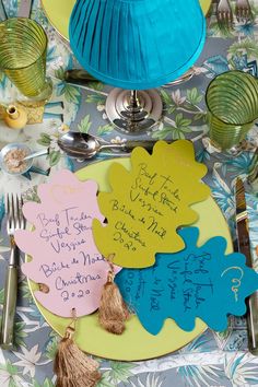 a table topped with plates covered in different types of paper decorations and writing on them