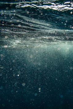 an underwater view of the water with bubbles