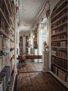 an old library with lots of books on shelves and a piano in the middle,