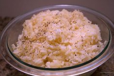 a glass bowl filled with rice and seasoning