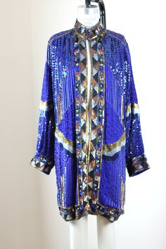 "An amazing Sequin Coat...with a Neru Collar, (oh so 60s/70s) and with loads of sparkles, beads and even some jewels.. A timeless piece..can be worn in for any special event and you will so stand out in a crowd!! Long, beautiful and in excellent condition! Measuring: 35\" length Width: 52\" Sleeves: 24\" Although tagged a size L, it can easily be worn for an Extra large as well.. Pet Free/smoke free Enjoy!" Vintage Blue Outerwear For Party, Vintage Festive Party Outerwear, Festive Vintage Party Outerwear, Vintage Beaded Party Outerwear, Festive Blue Party Outerwear, Blue Embellished Party Outerwear, Party Blue Sequined Outerwear, Blue Sequined Outerwear For Party, Sequin Coats