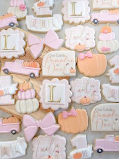 decorated cookies are arranged in the shape of baby's first names and other items