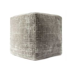 a square ottoman that is made out of fabric and has an interesting pattern on it