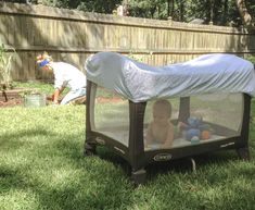 a baby in a crib with a cover over it and the words tips - n - tricks slip a fitted sheet over a pack & play to keep the bugs off the baby and provide shade while outside