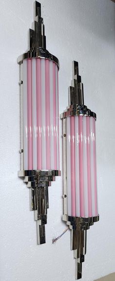 two pink candles are hanging on the wall