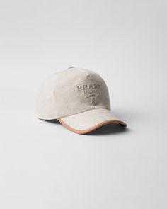 This classic sports-inspired baseball cap is made of a linen blend fabric with leather trim. The tonal lettering logo in relief embellishes the accessory with a distinctive touch. Classic Hats With Logo And Curved Visor, Classic Hats With Logo Detail And Curved Visor, Classic Hat With Logo And Curved Brim, Classic Hat With Logo Detail And Curved Brim, Classic Hat With Curved Brim And Logo Detail, Classic Cap With Logo Detail, Luxury Beige Visor Hat, Designer Brown Hat For Travel, Designer Baseball Cap With Embroidered Logo