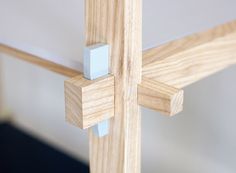 a close up of a wooden cross on the side of a wall with glass inserts