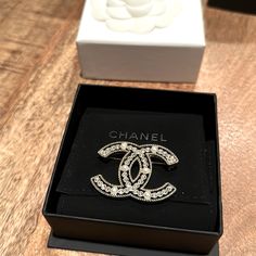 Preowned. In Original Box. Excellent Condition. Limited Edition Chanel Brooch. 6 Pearls And 38 Rhinestones. Designer Silver Brooches For Gifts, Luxury Diamond White Brooches For Formal Events, Luxury Diamond White Brooches For Formal Occasions, Luxury White Diamond Brooch, Luxury Brooches With Diamond Accents, Classic White Brooches For Evening, Classic White Evening Brooches, Classic White Diamond Brooches, Luxury Diamond Brooches In White Gold