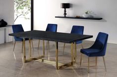 a dining room table with blue chairs and a black marble top in front of a white wall