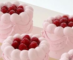 four cakes with raspberries in the shape of hearts