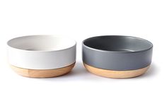 two white and grey bowls sitting next to each other