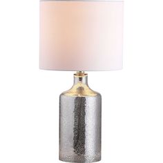 a silver and gold lamp with a white shade on the top, sitting against a white background