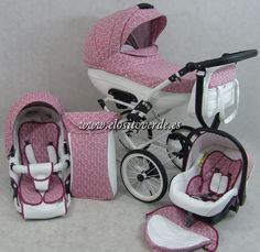 a pink and white baby stroller with matching accessories