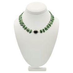 One-of-a-Kind Introducing a truly stunning necklace, featuring vivid deep green chrome Diopside gemstones. This recently discovered gemstone is found almost exclusively in Eastern Siberia and is known as Inagli. Each stone in this necklace has been expertly cut into small matching plates, with a rough texture on the top and a highly polished finish on the flat back. The arresting green of the Diopside stones is perfectly complemented by the delicate seed Pearls that separate them. The centerpiece of the necklace is a faceted Onyx, surrounded by shimmering Diamonds that add a touch of elegance and sophistication to the piece. To ensure comfort, the final 2 inches on each side of the back of the necklace feature small emeralds, Onyx, and seed pearls. The Silk hand-knotted design ensures dura Silk Design, Green Chrome, Rough Texture, Onyx Necklace, Seed Pearl, Stunning Necklace, Strand Necklace, Deep Green, Timeless Pieces