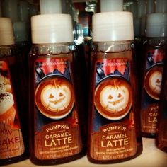 three bottles of pumpkin latte on a shelf