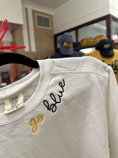 a t - shirt with the word love on it hanging from a rack in a store