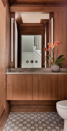 a bathroom with wood paneling and tile flooring