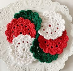 three crocheted flowers on a white plate