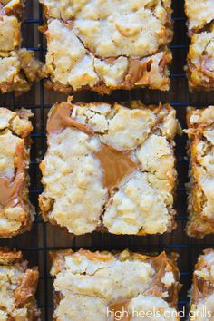 peanut butter bars on a cooling rack with caramel drizzled on top