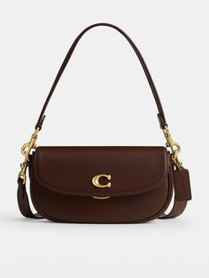 COACH Emmy 23 Glovetanned Leather Saddle BagSize & FitDimensions: Height: 13.5cm x Width: 23cm x Depth: 5cmHandle drop: 21cm Strap drop: 54cm DetailsEmmy 23 Glovetanned Leather Saddle Bag by CoachBrown Small but mighty, the Emmy is a chic, compact saddle bag that's perfect for days where you only need your essentials - wear snug on the shoulder or style across the body for effortless hands-free appeal Roomy enough to store your phone, keys, a lip balm and a small purse Crafted from buttery soft glovetanned leatherSignature C logo to the front Flap closure with a clasp fastening Includes a short removable handle and a detachable long shoulder strap for versatile stylingGold-tone metal hardware throughout Internal slip and zip pockets Material & Care Purse Crafts, Leather Saddle Bags, C Logo, Signature Hardware, Saddle Bag, Small Purse, Big Deal, Saddle Bags, Inside Pocket