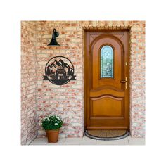 a wooden door sitting in front of a brick wall next to a potted plant