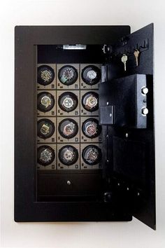 a wall mounted watch display in a black frame with keys and keypads on it