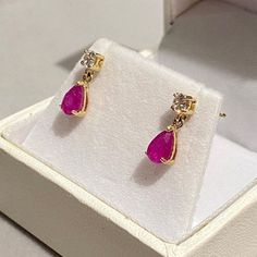 Give your loved one the ultimate gift, a pair of classic genuine Ruby set earrings set within UK hallmarked 9ct Yellow Gold.  A dainty classic design, little drops, just stunning! RUBY & SAPPHIRE are available for 2-3 days delivery ... we are busy making further pairs using our other gemstones... those will take a few weeks i'm afraid. Metal: Solid 9ct Yellow Gold ( Fully Hallmarked )   Info: Nickel Free Stone: Genuine Red Ruby, Pear Cut & Simulated Diamond Free Gift: Jewellery Polishing Cloth Quantity: Sold as a pair Type: Specifically designed for the lobe Size: Total length 12mm  Fixing: 9ct Hallmarked Gold Butterfly Backs  Colour: Ruby Red / Pink NOTE: In general due to health & safety reasons, earrings are non returnable unless there is a description error, or have incurred damage in Classic Hallmarked Earrings For Valentine's Day, Classic Diamond Cut Earrings For Valentine's Day, Yellow Gold Drop Diamond Earrings For Gift, Yellow Gold Teardrop Diamond Earrings Gift, Classic Ruby Birthstone Earrings, Classic Pink Hallmarked Earrings, Classic Earrings For Valentine's Day, Ruby Earrings With Prong Setting, Drop Diamond Earrings With Prong Setting As Gift