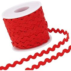 a roll of red ribbon on a white background