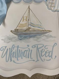 a glass plaque with a sailboat on it and the words hawaiian red written in blue