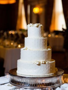 a white wedding cake sitting on top of a table