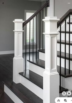 the stairs in this house have black and white railings