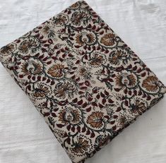 a square piece of cloth with flowers and leaves on it