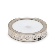 a silver plate with an intricate design on the rim and bottom, sitting on a white surface