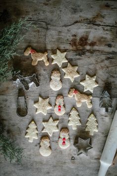 some cookies are arranged on a table with decorations and utensils next to them