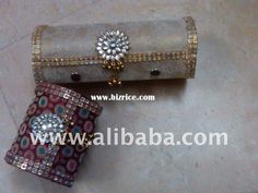 two clutches are sitting on the floor next to each other and one has a jeweled clasp