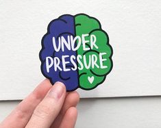 someone is holding up a sticker with the words under pressure and brain on it