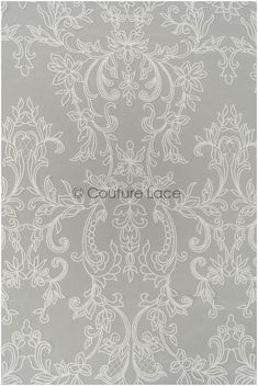 a gray and white wallpaper with an ornate design