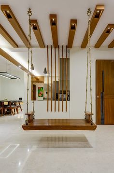 a wooden swing in the middle of a room