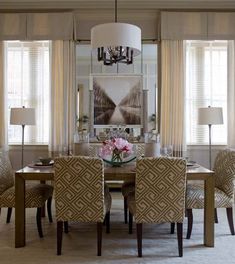 a dining room table with chairs and a chandelier