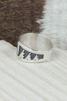 This sterling silver ring was made by Hopi silversmith Timothy Mowa. The inside is stamped sterling.Size: 12Length: 1"Free shipping on all orders! We ship with USPS and always include tracking. All orders ship within a day of payment.Returns are accepted up to 30 days after you receive your order. Just send us a message. Our shop offers cash back or store credit. The item must be returned in new condition. Artisan Engraved Sterling Silver Ring 925, Silver Sterling Silver Signet Ring, Artisan Sterling Silver Wide Band Ring, Sterling Silver Inlay Ring, Sterling Silver Inlay Ring For Anniversary, Unique Silver Ring With Inlay, Native American Jewelry, Free Jewelry, Sterling Silver Ring