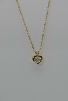 "14K Yellow Gold Diamond Heart Pendant, HSI, app .5 ct, 5mm stone floats on a white and gold mount on rabbit ear bail, chain length 18\" chain, 1.8 grams. Stock # BB127N06 This listing contains photographs of the actual item you will receive. Our items are in excellent condition with little or no signs of wear and many are one of a kind pre-owned estate finds. Please look closely at the pictures in this listing as they are part of the product description. Please read the description, as any impe Heart-shaped Yellow Gold Jewelry With Single Diamond, Gold Heart-shaped Diamond Necklace With Single Diamond, Yellow Gold Heart Cut Jewelry With Single Diamond, Gold Heart Necklace With Single Cut Diamonds For Gift, Gold Heart Necklace With Single Cut Diamonds For Anniversary, Gold Heart Cut Single Diamond Necklace, Gold Necklace With Heart Cut Single Diamond, Gold Necklaces With Single Diamond Heart Cut, Heart Cut Gold Necklace With Single Diamond