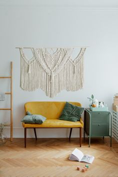 a yellow couch sitting on top of a hard wood floor