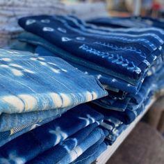 blue jeans are stacked on top of each other