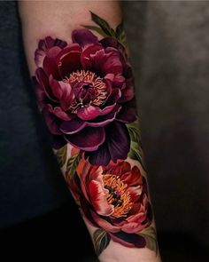 a woman's arm with flowers painted on it