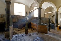 the inside of an old building with stone floors and pillars