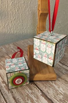 an ornament is sitting on top of a wooden stand with a red ribbon